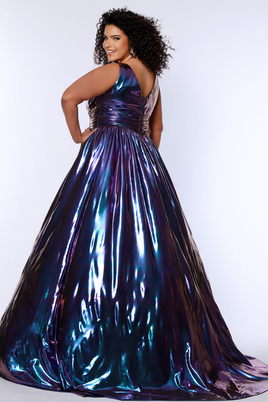Best selling plus size A-line prom, formal and evening dress. Metallic stretch knit novelty fabric, bra-friendly straps, full A-line skirt and pockets. Available in peacock (blue/green) and Prism (blue/purple) sizes 14-40. SC7415 by Sydney's Closet