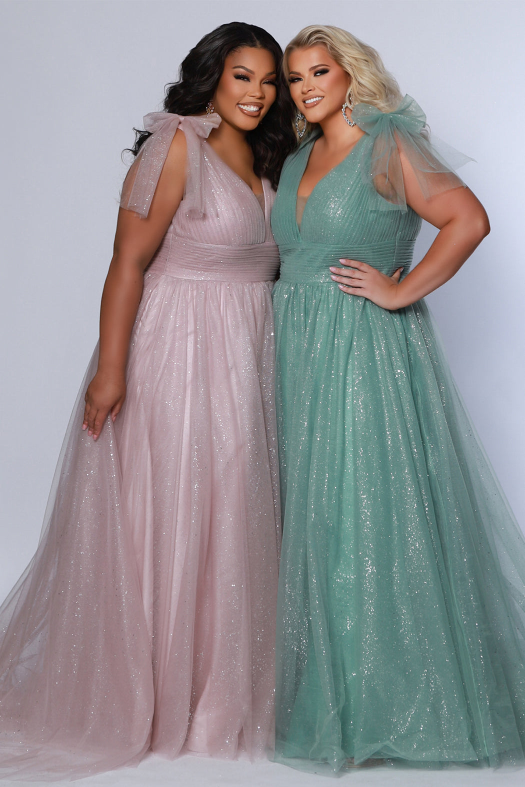 Plus Size princess A-line prom dress with bra-friendly straps, pleated bodice, pleated waistband and full A-line skirt with train. Detachable bows on shoulder. SC7417 in ice blue, mauve or sage green from Sydney's Closet.