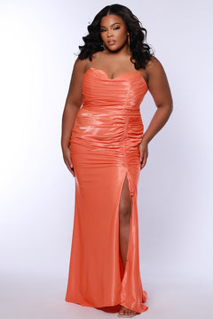 Slim fitted stretch satin plus size formal prom dress.  Pleated bodice, ruched skirt with gathered ties on slit, spaghetti straps and ruched back skirt with train.  Availablie in light blue, orange and lilac in sizes 14-24. Style SC7422 by Sydney's Closet. 