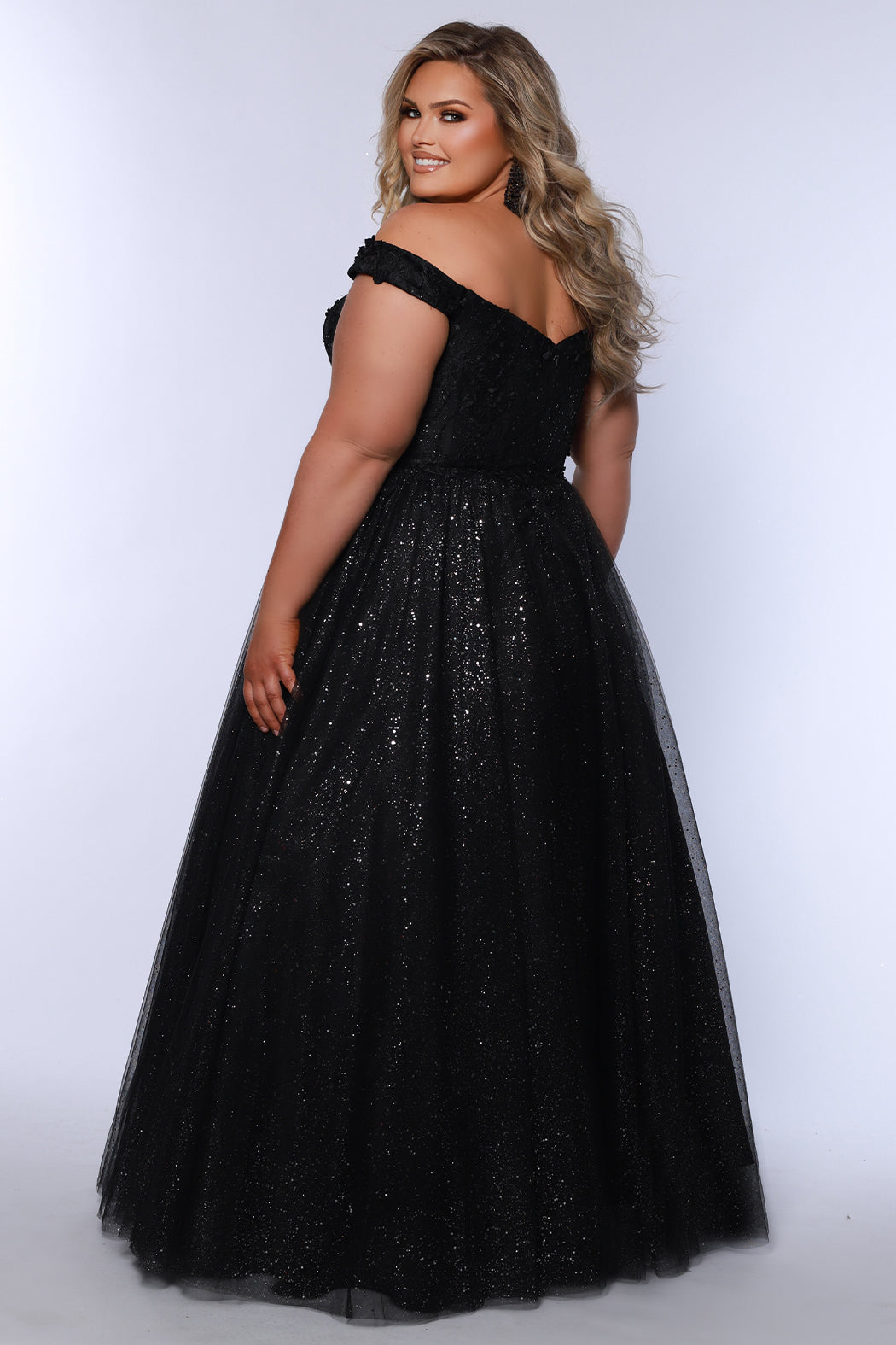 Plus size elegeant off-the-shoulder ball gown with 3D floral lace and sparkle tulle. Full A-line skirt and center back zipper. Availablie in burgundy red, onyx black and plum purple in plus sizes 14-40. Style SC7428 from Sydney's Closet.