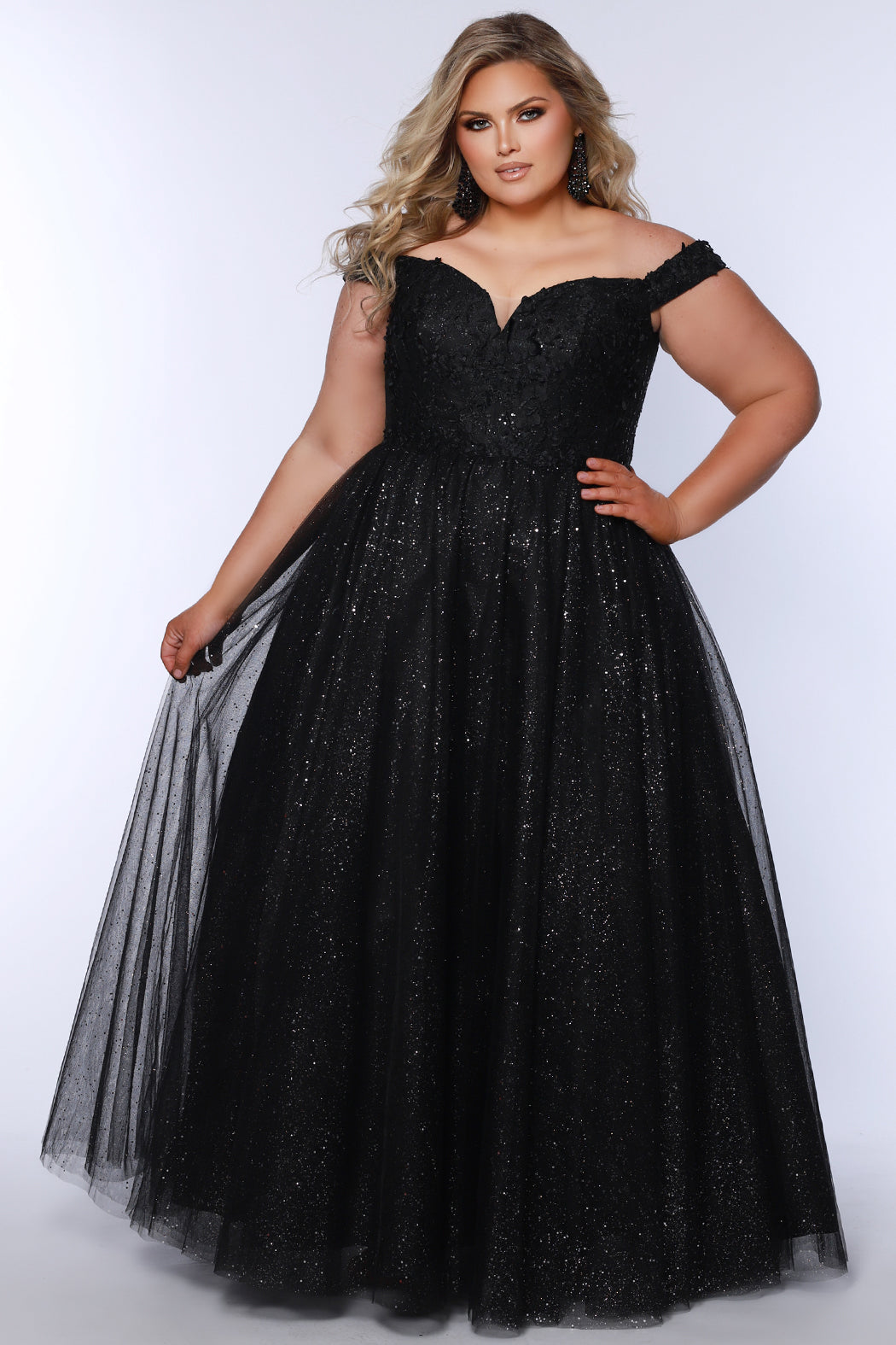 Plus size elegeant off-the-shoulder ball gown with 3D floral lace and sparkle tulle. Full A-line skirt and center back zipper. Availablie in burgundy red, onyx black and plum purple in plus sizes 14-40. Style SC7428 from Sydney's Closet.