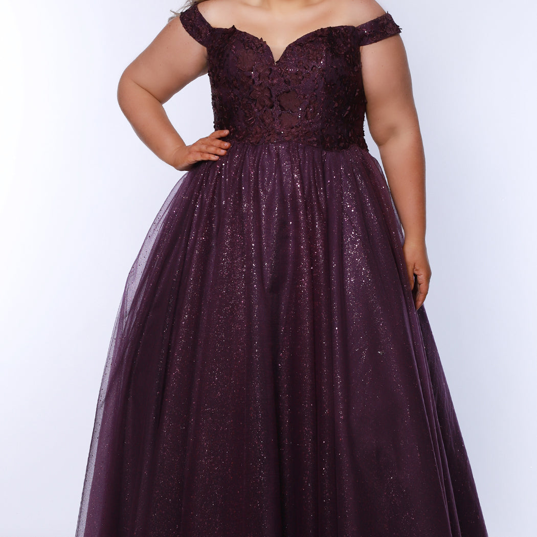 Plus size elegeant off-the-shoulder ball gown with 3D floral lace and sparkle tulle. Full A-line skirt and center back zipper. Availablie in burgundy red, onyx black and plum purple in plus sizes 14-40. Style SC7428 from Sydney's Closet.