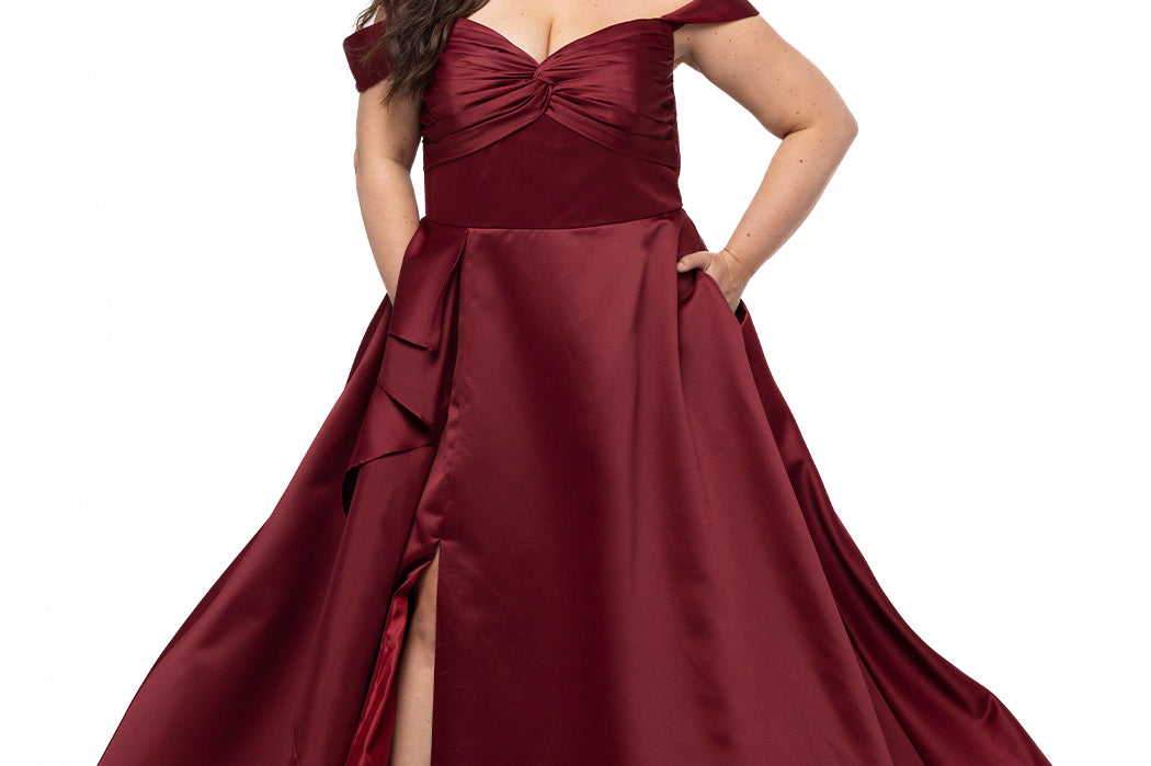 Plus Size Prom & Formal dress by Sydney's Closet - Style SC7431 shown in Burgundy Red. 

A-line silhouette, sweetheart neckline with pleated bust and knot details, detachable off the shoulder straps, natural waistline, A-line skirt with pocket and sexy slit with founce ruffle detail. 