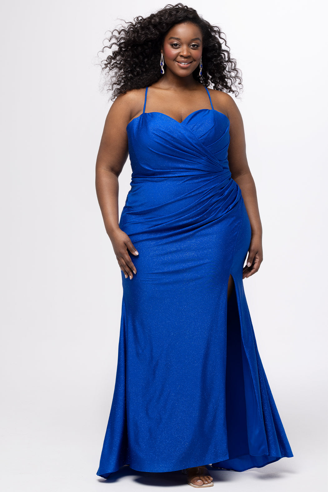 Sydney's Closet style SC7434 in Sapphire Blue. 

Slim, fitted silhouette, sweeetheart neckline, pleated bodice, anutral waistline, ruched skirt with left leg slit, sweep train and spaghetti straps that criss-cross in the back and go into the lace up back with modesty panel. 