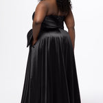 Sydney's Closet style SC7437 in black. 

Plus size A-line formal dress with strapless, pleated bodice, natural waistline with detachable oversized bow, A-line skirt with horsehair hem in silky satin fabric.