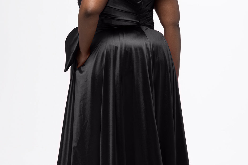 Sydney's Closet style SC7437 in black. 

Plus size A-line formal dress with strapless, pleated bodice, natural waistline with detachable oversized bow, A-line skirt with horsehair hem in silky satin fabric.