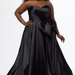 Sydney's Closet style SC7437 in black. 

Plus size A-line formal dress with strapless, pleated bodice, natural waistline with detachable oversized bow, A-line skirt with horsehair hem in silky satin fabric.