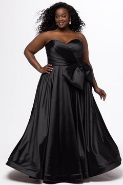 Sydney's Closet style SC7437 in black. 

Plus size A-line formal dress with strapless, pleated bodice, natural waistline with detachable oversized bow, A-line skirt with horsehair hem in silky satin fabric.
