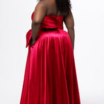 Sydney's Closet style SC7437 in pink. 

Plus size A-line formal dress with strapless, pleated bodice, natural waistline with detachable oversized bow, A-line skirt with horsehair hem in silky satin fabric.