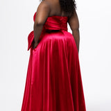 Sydney's Closet style SC7437 in pink. 

Plus size A-line formal dress with strapless, pleated bodice, natural waistline with detachable oversized bow, A-line skirt with horsehair hem in silky satin fabric.