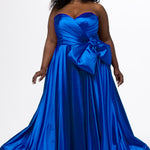 Sydney's Closet style SC7437 in royal blue. 

Plus size A-line formal dress with strapless, pleated bodice, natural waistline with detachable oversized bow, A-line skirt with horsehair hem in silky satin fabric.