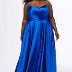 Sydney's Closet style SC7437 in royal blue. 

Plus size A-line formal dress with strapless, pleated bodice, natural waistline with detachable oversized bow, A-line skirt with horsehair hem in silky satin fabric.