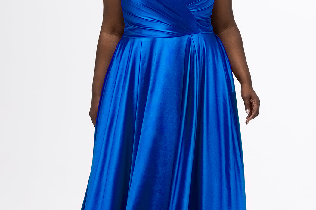 Sydney's Closet style SC7437 in royal blue. 

Plus size A-line formal dress with strapless, pleated bodice, natural waistline with detachable oversized bow, A-line skirt with horsehair hem in silky satin fabric.