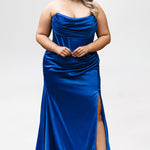 Sydney's Closet style SC7438 in cobalt or cobalt/nude. 

Slim, fitted silhouette with cay eye bodice and hot fix stone detail. Pleated drape over the bust line, exposed corset boning, basque waistline and slim fitted skirt with ruching and slit.  

Choose from tone-on-tone back bodice or color with nude lining on the upper back bodice. 