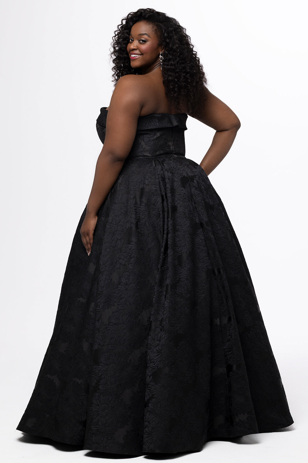 Sydney's Closet style SC7439 in black floral brocade.

A-line silhouette, strapless neckline with fold over cuff detail, natural waistline, full a-line skirt with box pleats, crinoline and pockets.