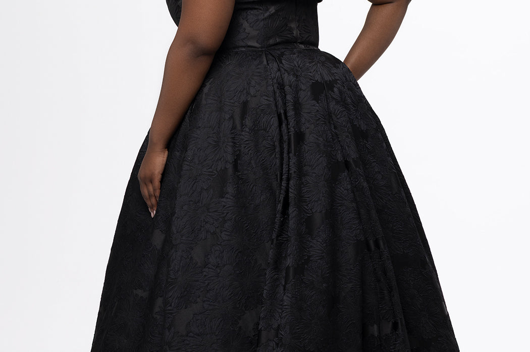 Sydney's Closet style SC7439 in black floral brocade.

A-line silhouette, strapless neckline with fold over cuff detail, natural waistline, full a-line skirt with box pleats, crinoline and pockets.