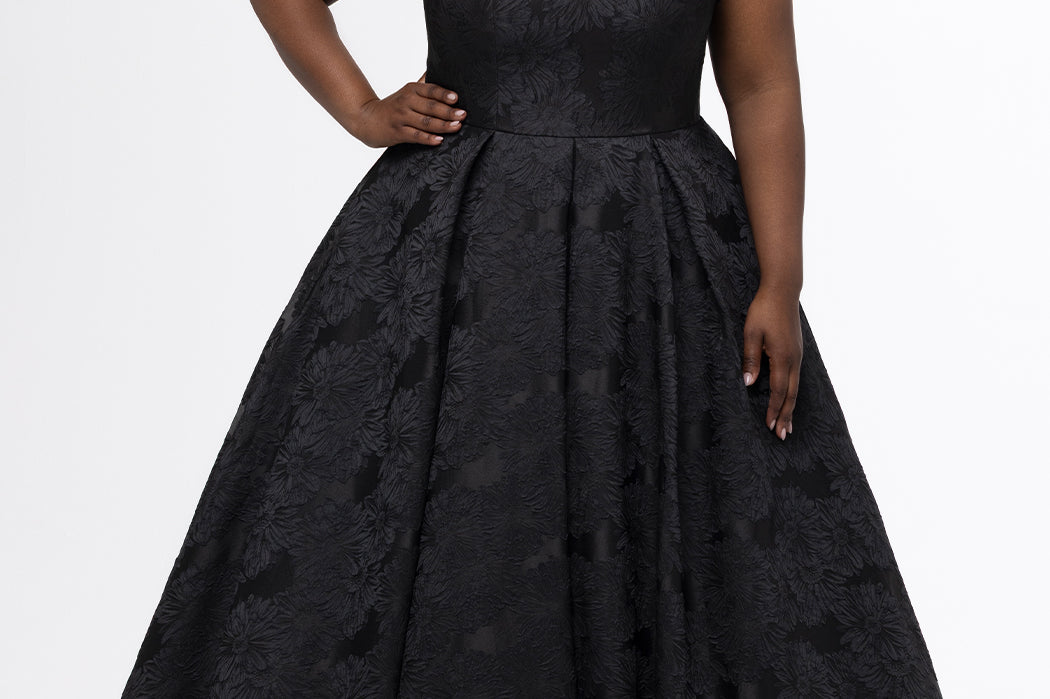 Sydney's Closet style SC7439 in black floral brocade.

A-line silhouette, strapless neckline with fold over cuff detail, natural waistline, full a-line skirt with box pleats, crinoline and pockets.