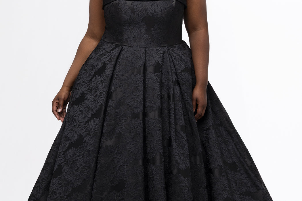 Sydney's Closet style SC7439 in black floral brocade.

A-line silhouette, strapless neckline with fold over cuff detail, natural waistline, full a-line skirt with box pleats, crinoline and pockets.