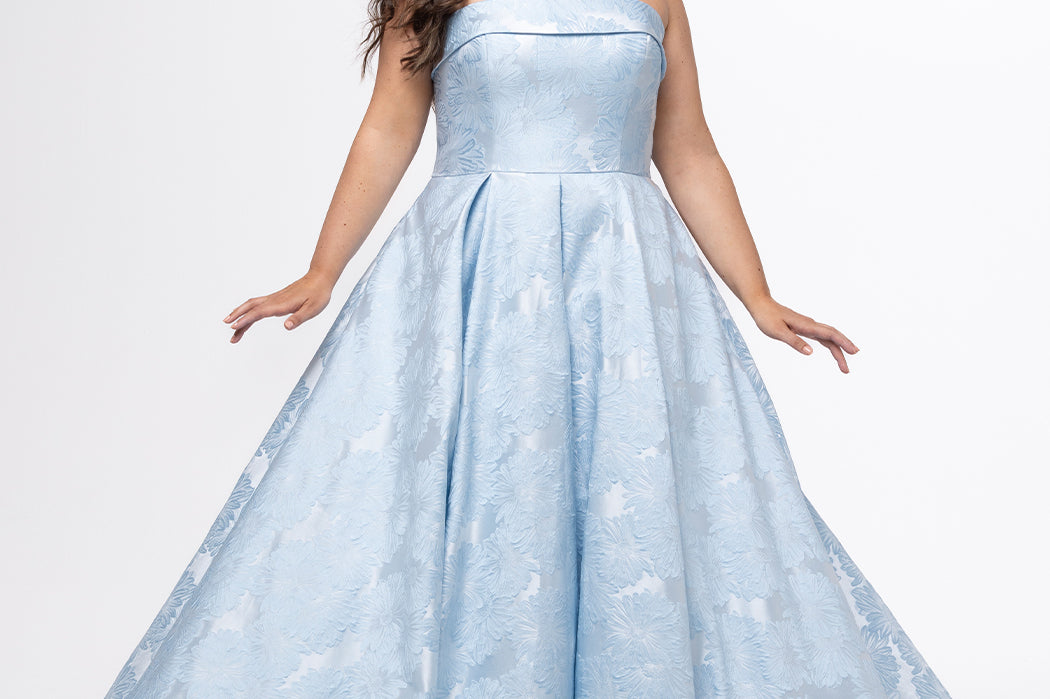 Sydney's Closet style SC7439 in light blue floral brocade.

A-line silhouette, strapless neckline with fold over cuff detail, natural waistline, full a-line skirt with box pleats, crinoline and pockets.