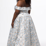 Sydney's Closet SC7440 in light blue floral brocade with gold accents.

Plus size A-line silhouette with off-the-shoulder neckline and fold over cuff on bodice.  Natural waistline with A-line skirt, pockets and left leg slit. 