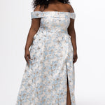Sydney's Closet SC7440 in light blue floral brocade with gold accents.

Plus size A-line silhouette with off-the-shoulder neckline and fold over cuff on bodice.  Natural waistline with A-line skirt, pockets and left leg slit. 
