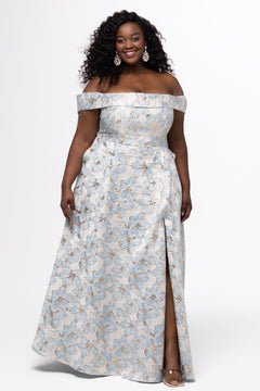 Sydney's Closet SC7440 in light blue floral brocade with gold accents.

Plus size A-line silhouette with off-the-shoulder neckline and fold over cuff on bodice.  Natural waistline with A-line skirt, pockets and left leg slit. 