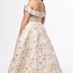 Sydney's Closet SC7440 in gold floral brocade.

Plus size A-line silhouette with off-the-shoulder neckline and fold over cuff on bodice.  Natural waistline with A-line skirt, pockets and left leg slit. 