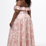 Sydney's Closet SC7440 in light pink floral brocade with gold accents.

Plus size A-line silhouette with off-the-shoulder neckline and fold over cuff on bodice.  Natural waistline with A-line skirt, pockets and left leg slit. 