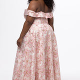 Sydney's Closet SC7440 in light pink floral brocade with gold accents.

Plus size A-line silhouette with off-the-shoulder neckline and fold over cuff on bodice.  Natural waistline with A-line skirt, pockets and left leg slit. 