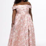 Sydney's Closet SC7440 in light pink floral brocade with gold accents.

Plus size A-line silhouette with off-the-shoulder neckline and fold over cuff on bodice.  Natural waistline with A-line skirt, pockets and left leg slit. 