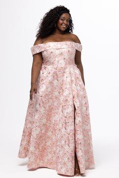 Sydney's Closet SC7440 in light pink floral brocade with gold accents.

Plus size A-line silhouette with off-the-shoulder neckline and fold over cuff on bodice.  Natural waistline with A-line skirt, pockets and left leg slit. 