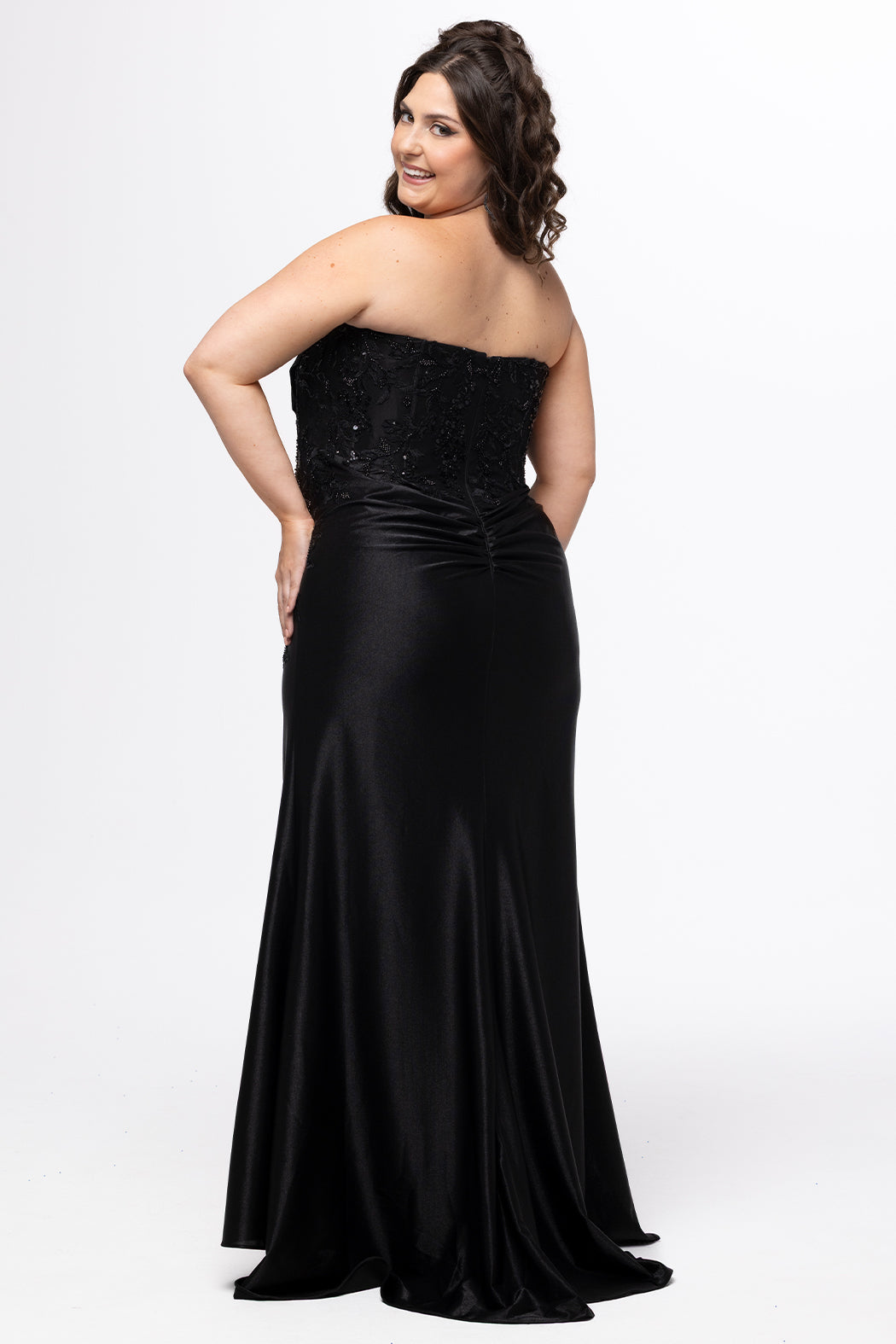 Sydney;s Closet style SC7441 in black.

Slim, fitted silhouette with strapless sweetheart neckline and pleated drape detaile.  Exposed corset boning, basque waistline and slim skirt with ruching, high slit and sweep train.  

Bodice features tone-on-tone lace with tone-on-tone beading that carries into the top of the slit.