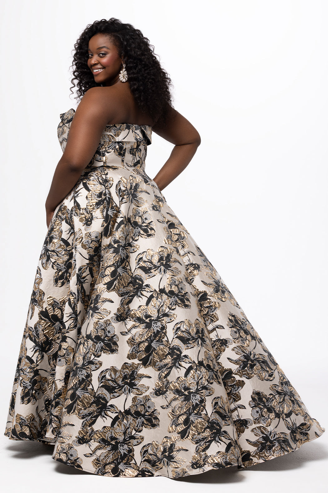 Sydney's Closet style SC7443 in Black/Gold metallic floral brocade.  A-line silhouette, strapless sweetheart neckline with fold over cuff, exposed corset boning on bustier bodice, basque waistline, A-line skirt with pockets and slit.