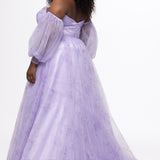 Sydney's Closet style SC7445 in lilac purple floral. 

Plus size A-line strapless formal dress in tulle.  Strapless, pleated, sweetheartneckline, natural waistline, A-line skirt with slit and pockets with detachable puff sleeves.