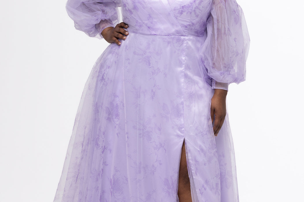 Sydney's Closet style SC7445 in lilac purple floral. 

Plus size A-line strapless formal dress in tulle.  Strapless, pleated, sweetheartneckline, natural waistline, A-line skirt with slit and pockets with detachable puff sleeves.