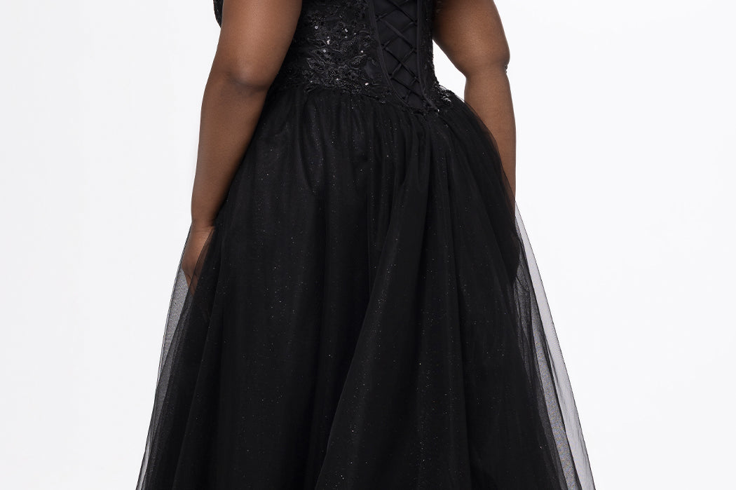 Sydney's Closet style SC7450 in black.

Ball gown silhouette, strapless bodice with deep V-mesh insert covered in lace appliques and exposed corset boning. Basque waistline and full sparkle tulle a-line skirt. Lace up back with modesty panel. 