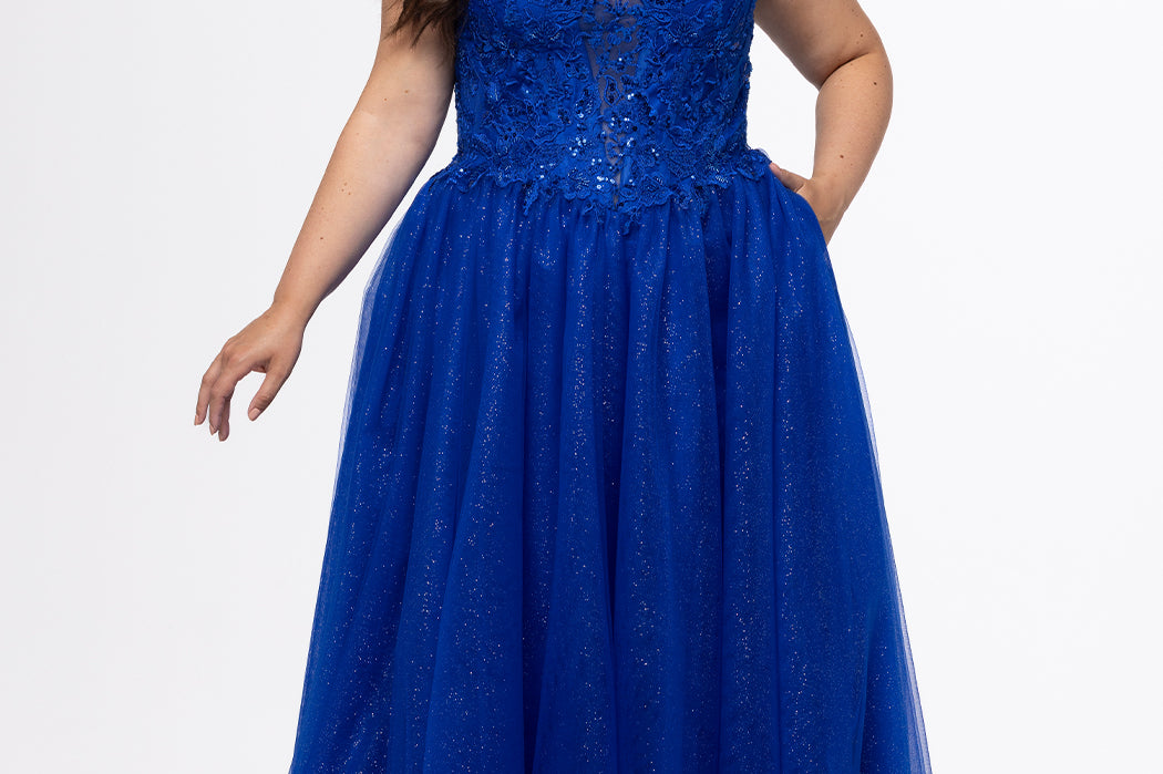 Sydney's Closet style SC7450 in royal blue.

Ball gown silhouette, strapless bodice with deep V-mesh insert covered in lace appliques and exposed corset boning. Basque waistline and full sparkle tulle a-line skirt. Lace up back with modesty panel. 
