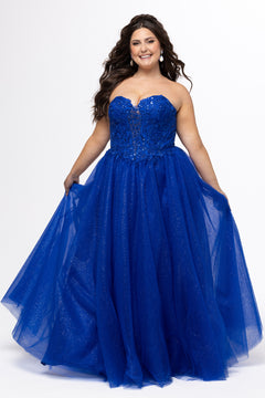 Sydney's Closet style SC7450 in royal blue.

Ball gown silhouette, strapless bodice with deep V-mesh insert covered in lace appliques and exposed corset boning. Basque waistline and full sparkle tulle a-line skirt. Lace up back with modesty panel. 
