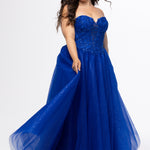 Sydney's Closet style SC7450 in royal blue.

Ball gown silhouette, strapless bodice with deep V-mesh insert covered in lace appliques and exposed corset boning. Basque waistline and full sparkle tulle a-line skirt. Lace up back with modesty panel. 
