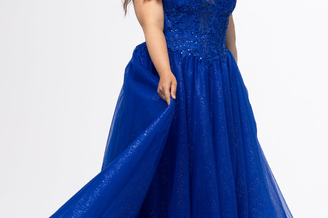 Sydney's Closet style SC7450 in royal blue.

Ball gown silhouette, strapless bodice with deep V-mesh insert covered in lace appliques and exposed corset boning. Basque waistline and full sparkle tulle a-line skirt. Lace up back with modesty panel. 