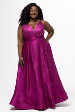 Sydney's Closet Style SC7453 in Magenta Pink

Plus Size A-line prom dress in metallic shimmer knit fabric, V-neckline with nude mesh insert, bra-friendly straps, pleated bodice, natural waisltine, A-line skirt with box pleats, pockets and a horsehair hem.