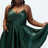 This is SC8124 in our Sydney's Closet Homecoming collection. This plus size party dress comes in black, red, green, and blue! This dress has spaghetti straps, a v neckline, and a beautiful rouched bodice! This a-line satin gown flows beautifully with your dance moves! With the length hitting right at your knees, and pockets, it is the perfect dress for this homecoming season!