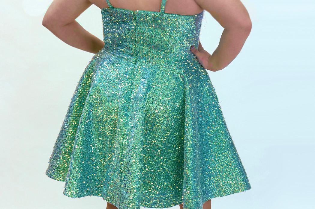This is SC8125 in our Sydney's Closet Homecoming collection. This plus size party dress comes in blue and green! This dress has spaghetti straps, a scooped neckline, and a natural waistline! This a-line quilted sequin gown has a horsehair hem that flows beautifully with your dance moves! To make this gown perfect, we have added pockets which is why you need it for this homecoming season!