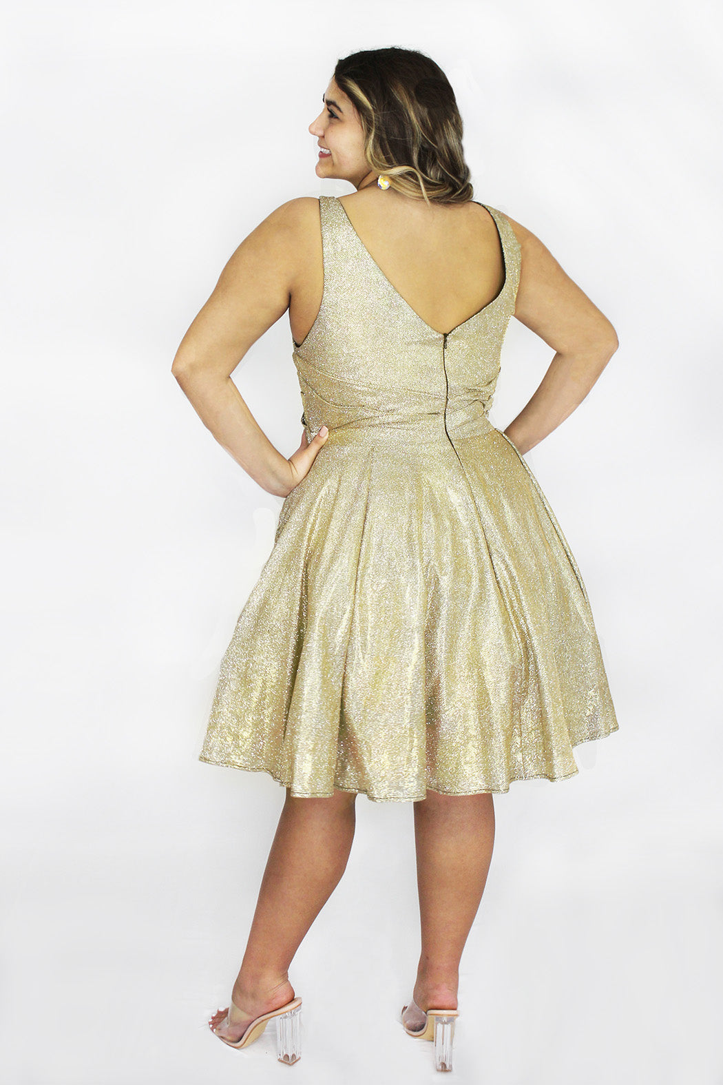 This is SC8132 in our Sydney's Closet Homecoming collection. This plus size party dress comes in black, blue, gold, and red! This dress has bra friendly straps, a v-neckline, and a pleated waistline. This metallic shimmer knit a-line dress has folds to make it flow so beautifully! This gown has pockets which makes it the most perfect for this homecoming season!