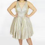 This is SC8132 in our Sydney's Closet Homecoming collection. This plus size party dress comes in black, blue, gold, and red! This dress has bra friendly straps, a v-neckline, and a pleated waistline. This metallic shimmer knit a-line dress has folds to make it flow so beautifully! This gown has pockets which makes it the most perfect for this homecoming season!