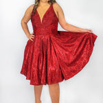This is SC8132 in our Sydney's Closet Homecoming collection. This plus size party dress comes in black, blue, gold, and red! This dress has bra friendly straps, a v-neckline, and a pleated waistline. This metallic shimmer knit a-line dress has folds to make it flow so beautifully! This gown has pockets which makes it the most perfect for this homecoming season!