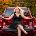 Woman in a black dress sitting on the back of a red pickup truck with autumn foliage in the background

Short A-line plus size flowy party dress SC8153 by Sydney's Closet in the color Onyx black. Front view. Layers of dense sparkle tulle and a satin lining. V-neckline with thick bra-friendly straps and detachable bows at the top of the shoulder. Pleated bodice and 3 inch pleated waistband. Pockets and long invisible center back zipper. Available in Shamrock green, Admiral blue, Firecracker red and Shamrock 