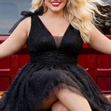 Woman in a black dress sitting on a red vehicle

Short A-line plus size flowy party dress SC8153 by Sydney's Closet in the color Onyx black. Front view. Layers of dense sparkle tulle and a satin lining. V-neckline with thick bra-friendly straps and detachable bows at the top of the shoulder. Pleated bodice and 3 inch pleated waistband. Pockets and long invisible center back zipper. Available in Shamrock green, Admiral blue, Firecracker red and Shamrock green in sizes 14-32. Model is 5'9. 