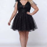Short A-line plus size flowy party dress SC8153 by Sydney's Closet in the color Onyx black. Front view. Layers of dense sparkle tulle and a satin lining. V-neckline with thick bra-friendly straps and detachable bows at the top of the shoulder. Pleated bodice and 3 inch pleated waistband. Pockets and long invisible center back zipper. Available in Shamrock green, Admiral blue, Firecracker red and Shamrock green in sizes 14-32. Model is 5'9. 