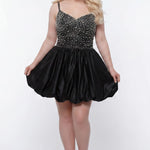 Plus-size model wearing a black sleeveless mini dress with a V-neckline, rhinestone & pearl embellished fitted bodice, and a voluminous bubble hem skirt. She is styled with long wavy blonde hair, dangling crystal earrings, and nude platform ankle-strap heels, posing against a light gray studio background while holding the sides of the skirt.

Sydney's Closet SC8171 in black